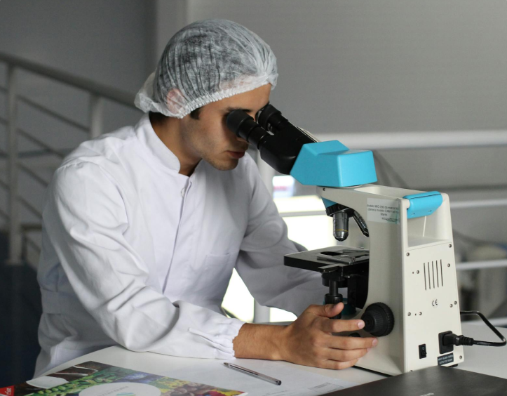 Scientist using microscope